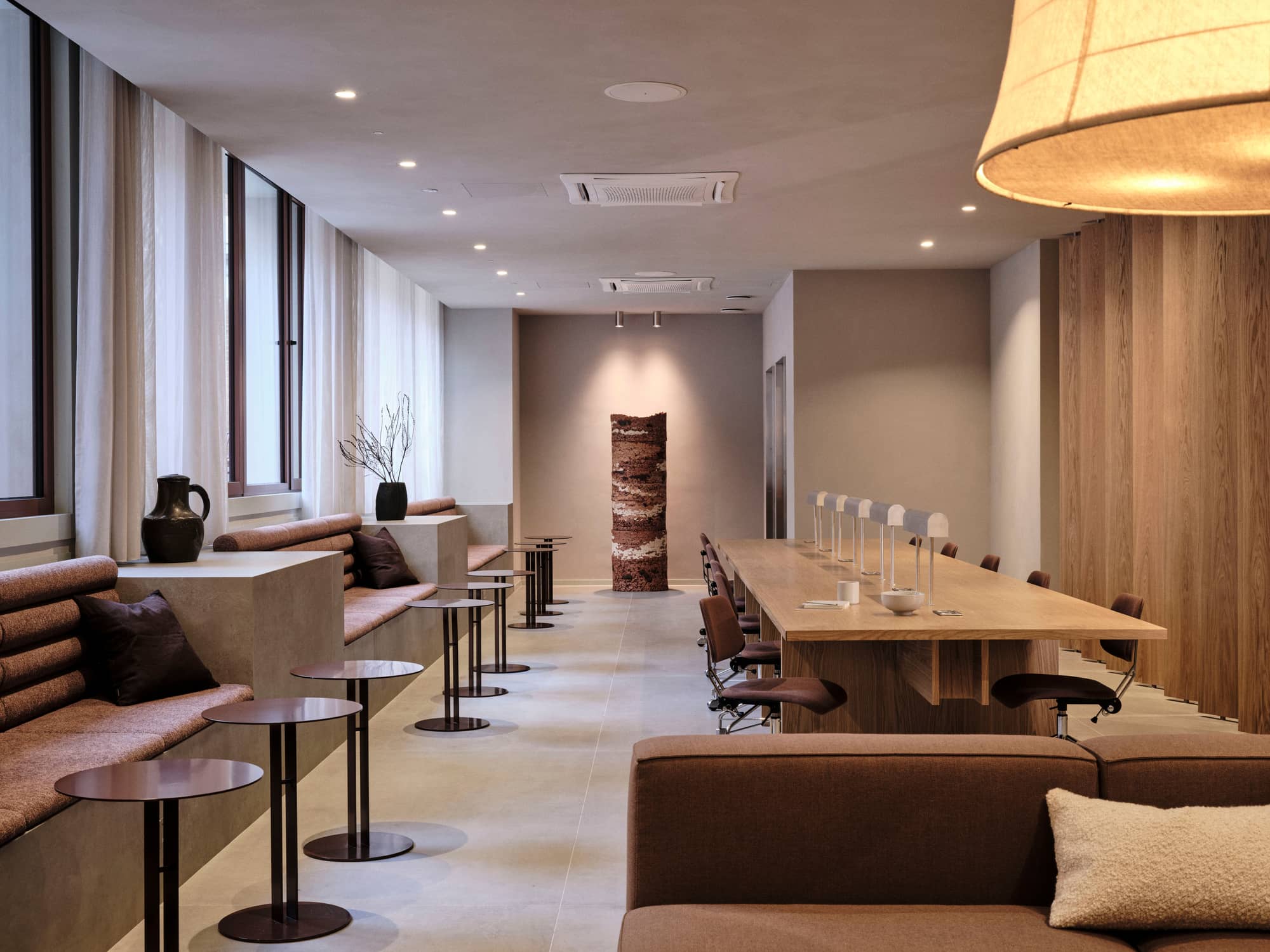 Communal workspace with built-in cushioned benches at Chancery House.