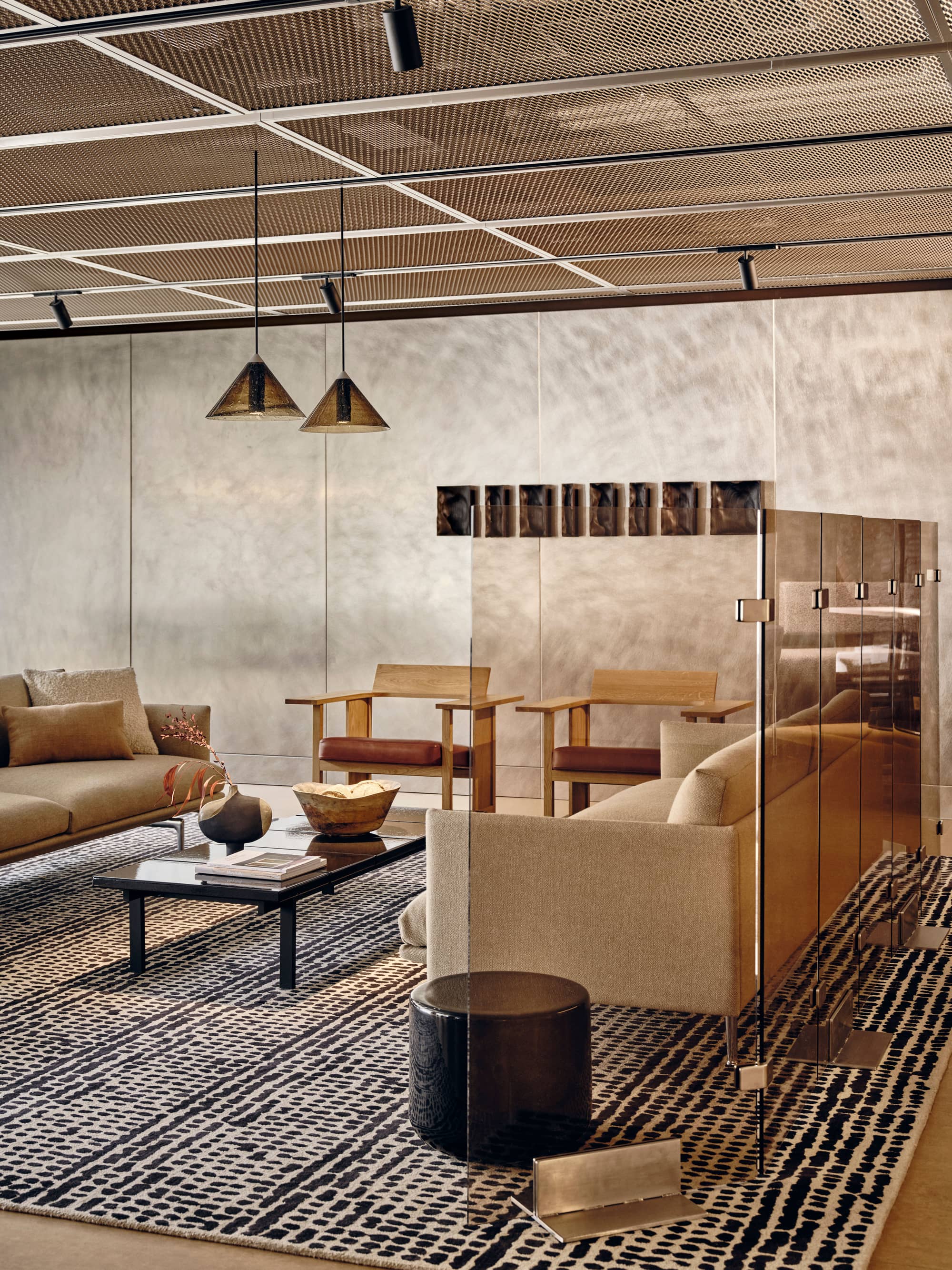 Communal seating area with modern seats, rug and coffee table at Borough Yards.