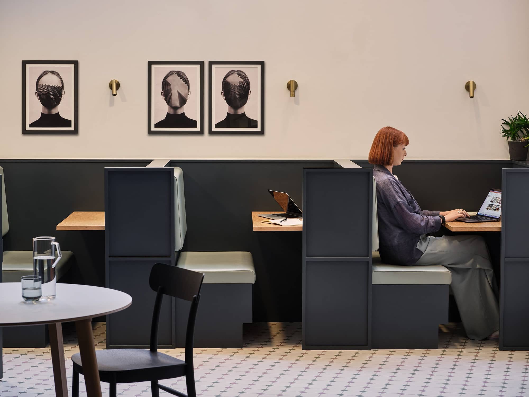 Woman working on her laptop in a booth at Warnford Court.