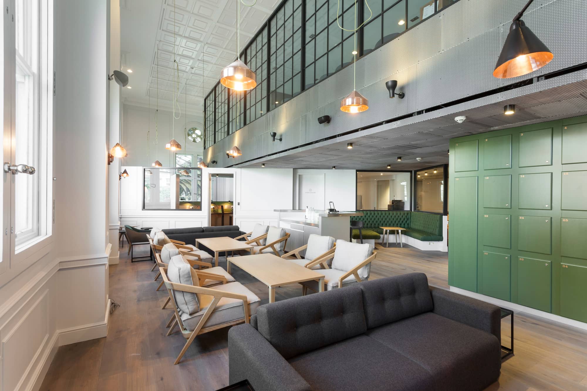 Modern, open-plan lounge with comfortable seating and lockers.