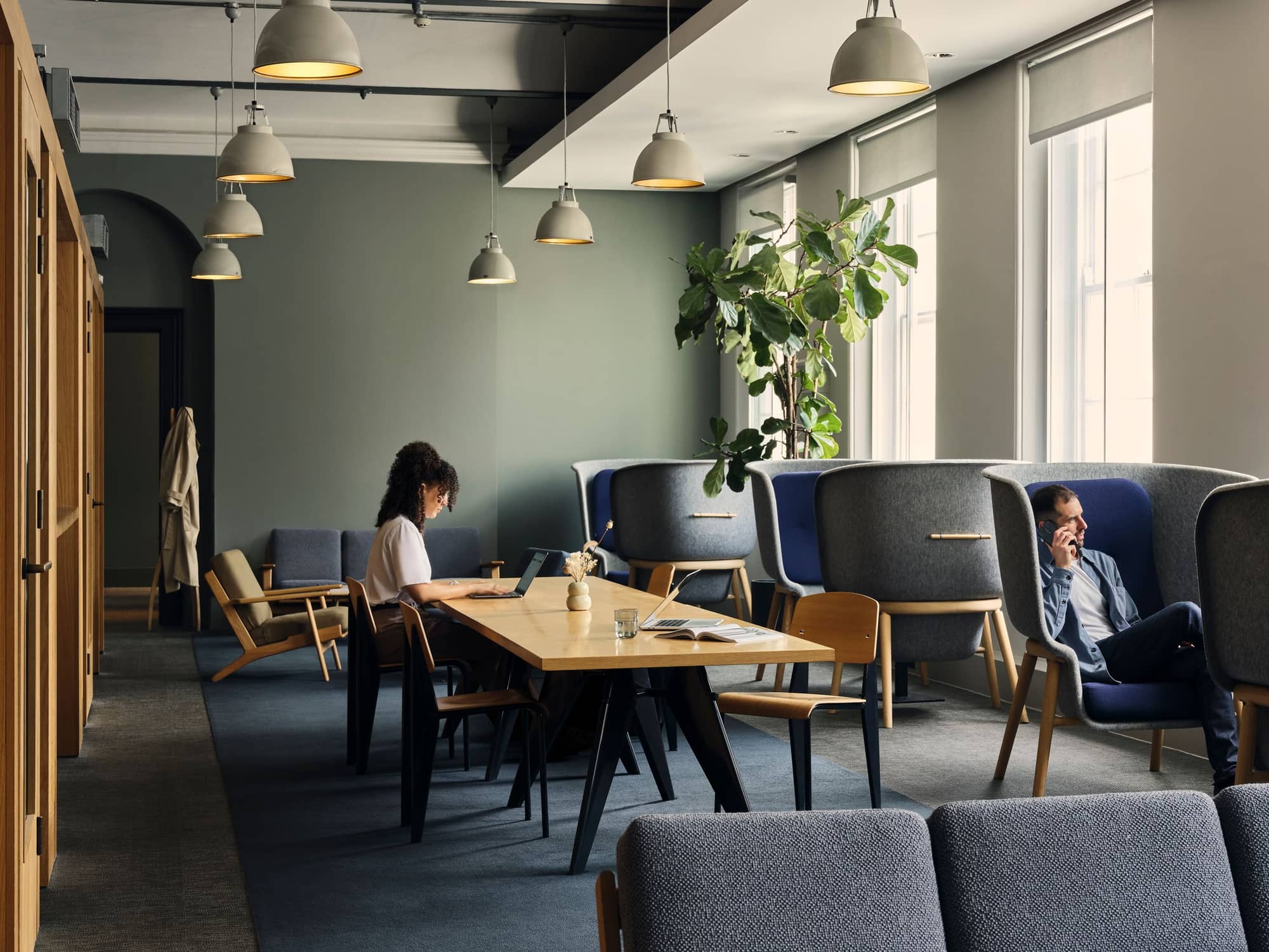 Man and woman in a serene coworking space with booth seating at 19 Eastbourne Terrace.