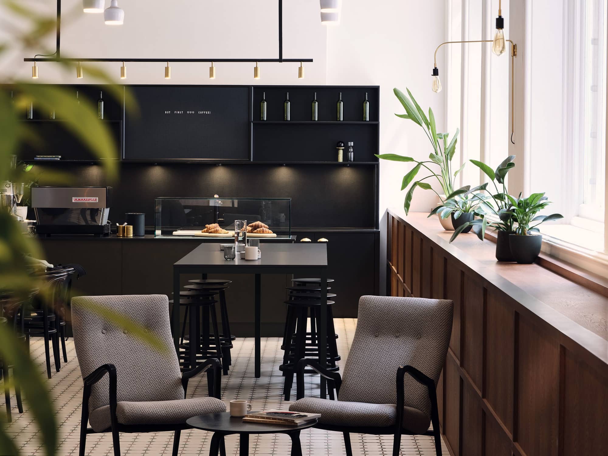 Café area at Warnford Court with sleek black furnishings and appliances.